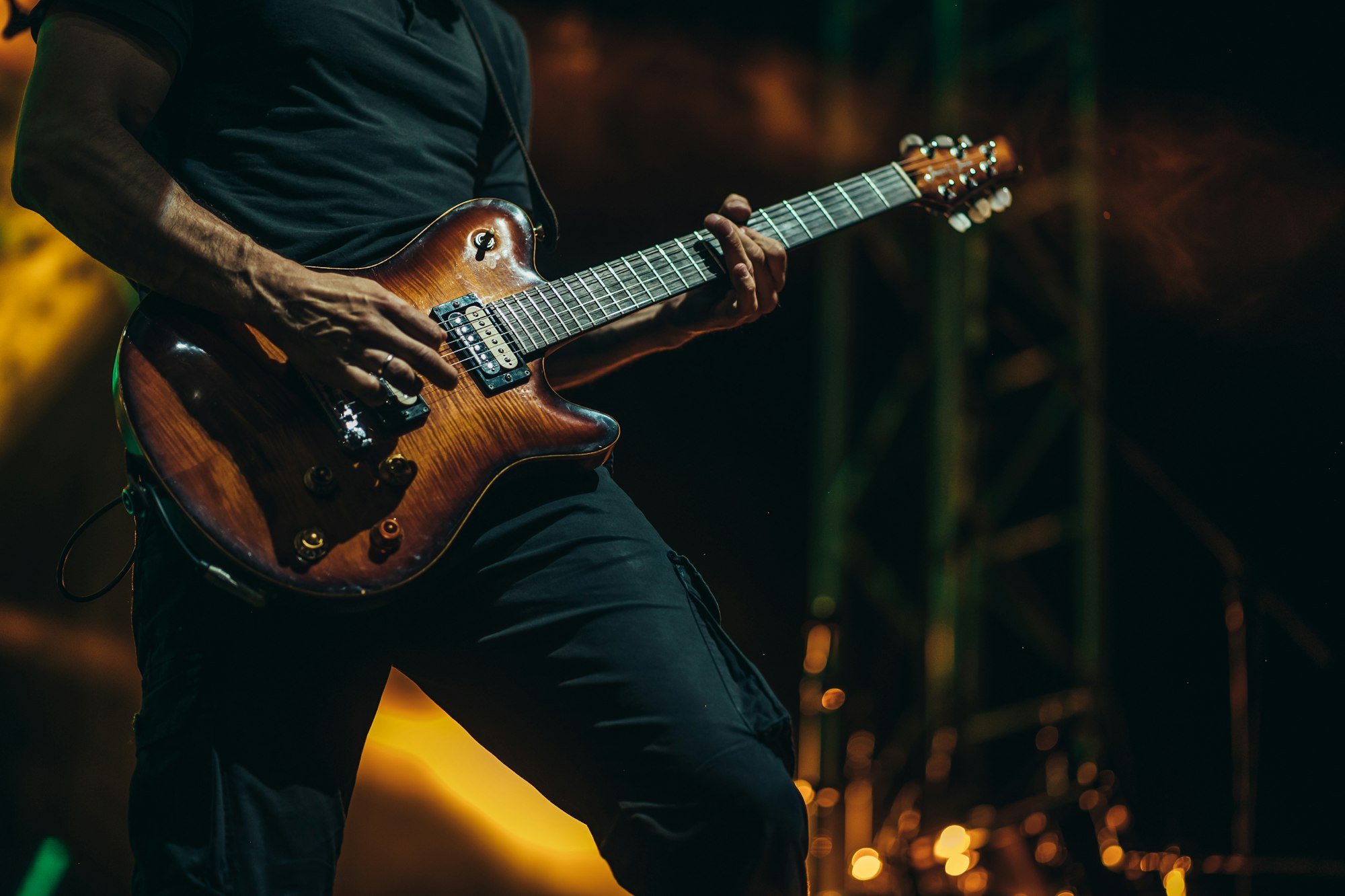 Musician playing guitar on a stage